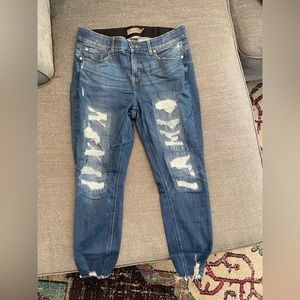 Distressed Bombshell skinny jeans with a distressed hem detail.